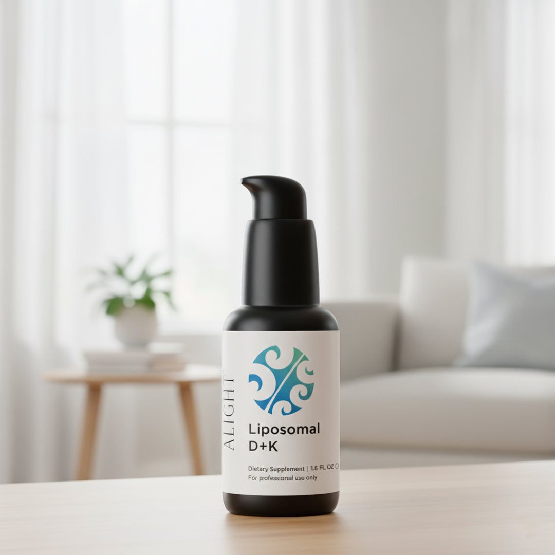 Bottle of Liposomal D+K supplement on a table with a blurred indoor background