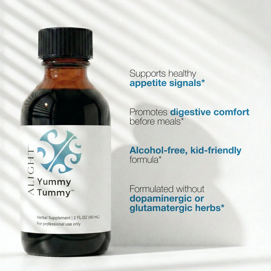 Bottle of Yummy Tummy supplement with label text on a white background