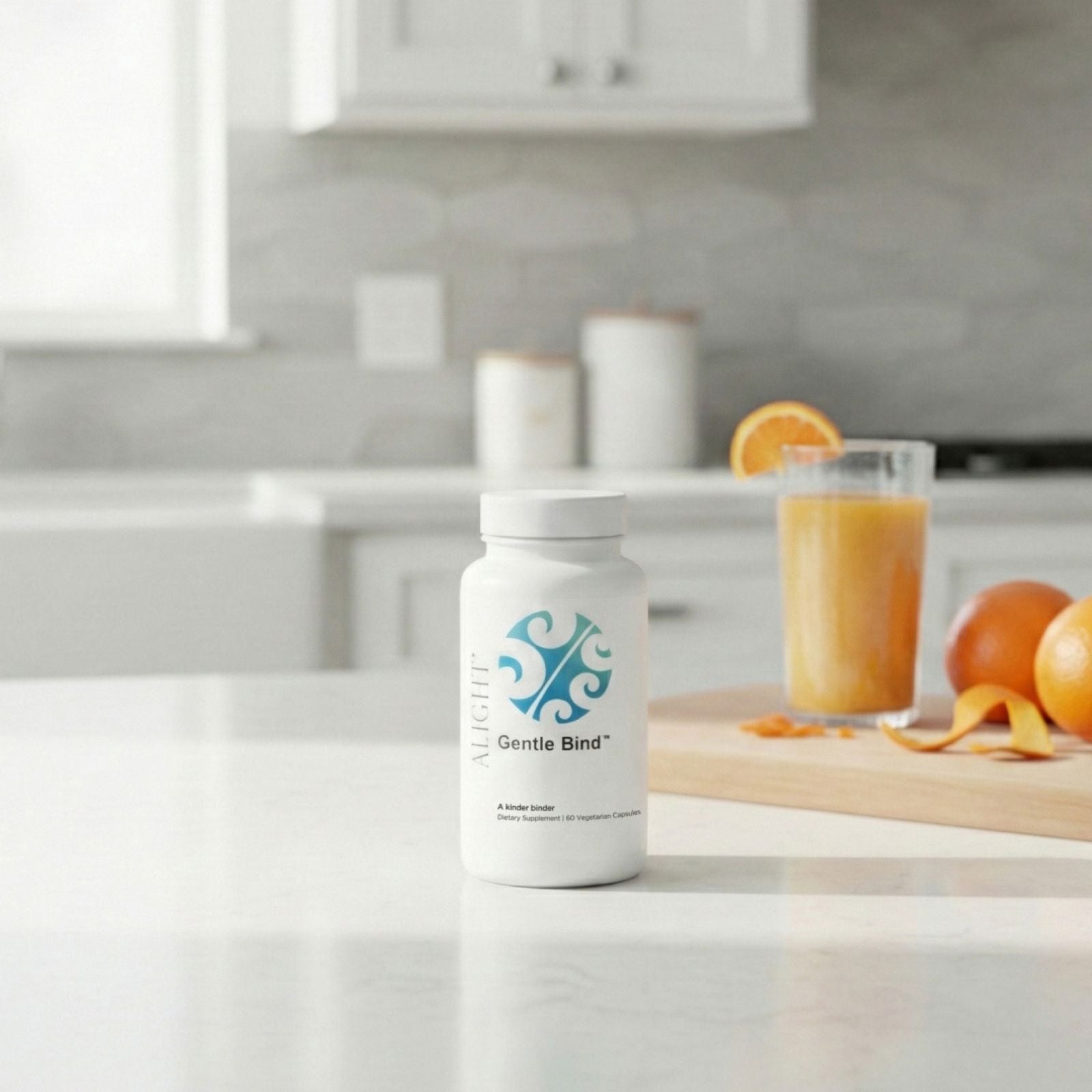 Bottle of 'Gentle Bind' on a kitchen counter with oranges and juice in the background