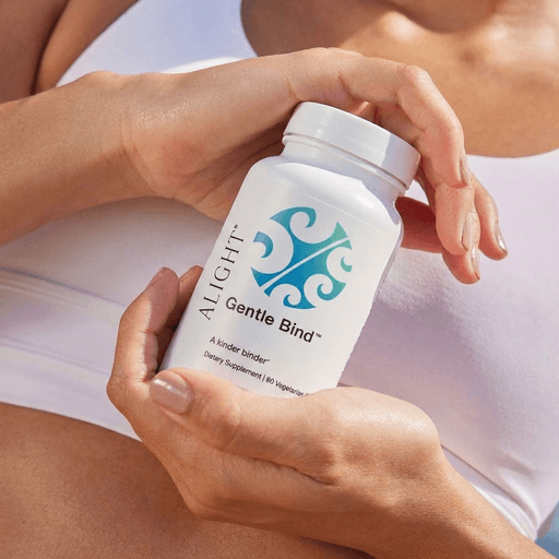 Woman's hands holding a bottle of Gentle Bind for mold binding. 