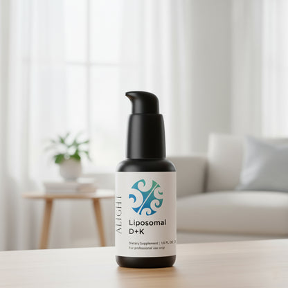 Bottle of Liposomal D+K supplement on a table with a blurred indoor background