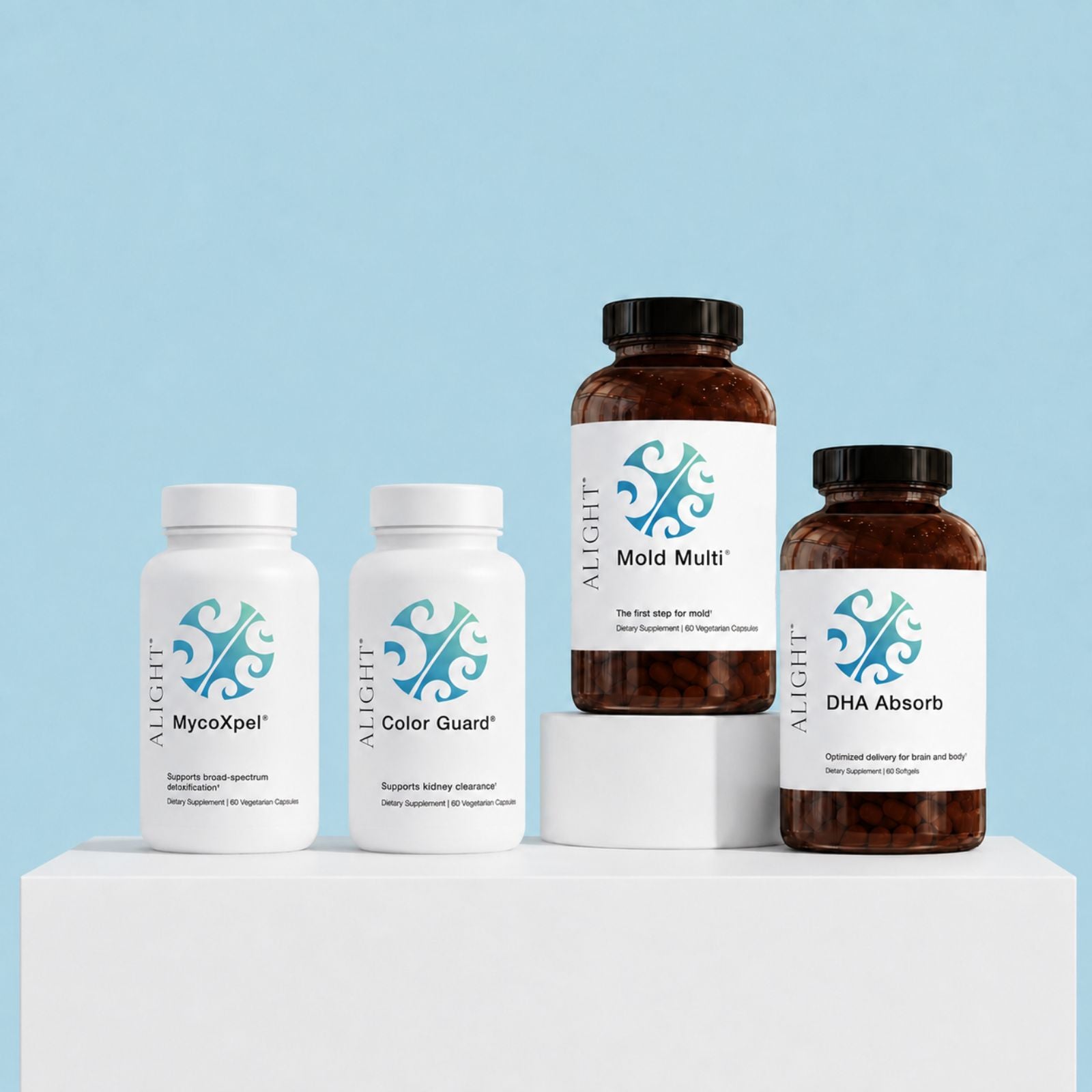 Four supplement bottles from the brand AIGHT arranged on white pedestals against a light blue background. The products include two white bottles labeled MycoXpel and Color Guard, and two amber brown bottles labeled Mold Multi and DHA Absorb.