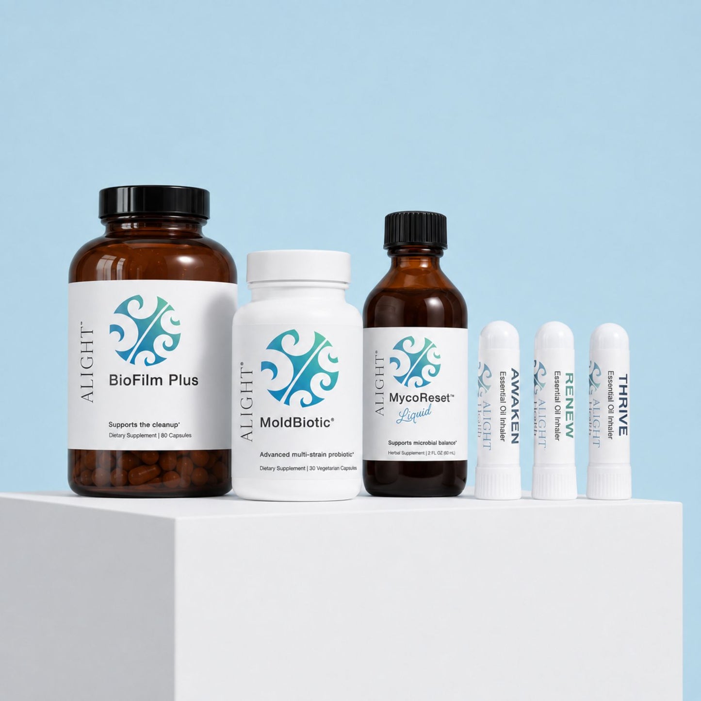 A bundle of six ALIGHT supplements arranged on a white block with a light blue background