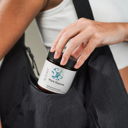 A person wearing a black bag slouches slightly while reaching into the side pocket to grab a small bottle labeled 'Ailight Pure Glycine'.