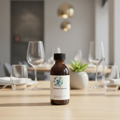 Bottle of 'Yummy Tummy' on a dining table with glasses and decor in the background